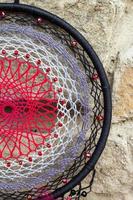 Dreamcatcher made of feathers, leather, beads, and ropes photo