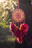 Handmade dream catcher with feathers threads and beads rope hanging photo