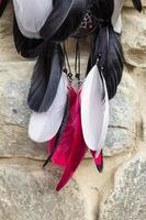 Dreamcatcher made of feathers, leather, beads, and ropes photo