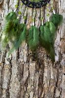 Handmade dream catcher with feathers threads and beads rope hanging photo