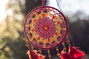 Handmade dream catcher with feathers threads and beads rope hanging photo