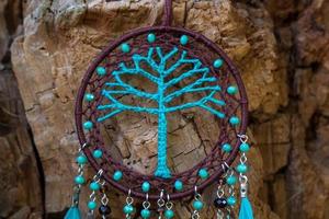 Handmade dream catcher with feathers threads and beads rope hanging photo