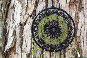 Handmade dream catcher with feathers threads and beads rope hanging photo