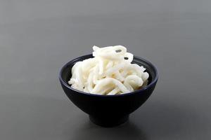 Japanese White Udon on Ceramic Bowl, isolated on Grey Table photo
