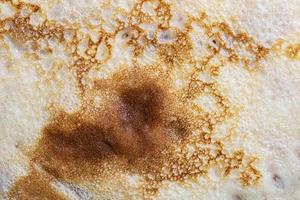 Pancake surface texture and pattern. Close-up of thin hot pancakes in a plate. Traditional rustic food. Graphic resource. photo