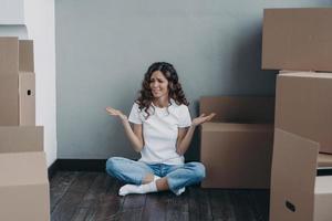 Nervous european woman has to pack the boxes. Homeowner getting stress from moving. photo
