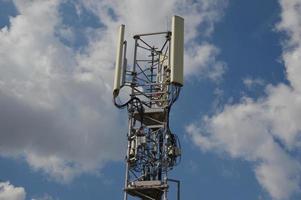A Telecommunication antenna mast with a slightly cloudy background, France photo
