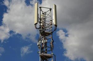 A Telecommunication antenna mast with a slightly cloudy background, France photo