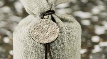 Grey linen bag close-up. Part of the bag in the blur on a gray background with bokeh. photo