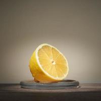 Lemon sliced in half lying on glass stand. Place for text. photo