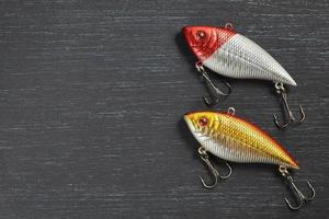 Two fishing lure Wobblers closeup on gray wooden background. Photo with copy space.