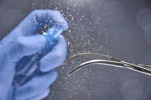 Disinfection of surgical instruments on a grey background. photo