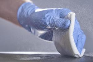 Soft-focus photo. Spray disinfectant on a gray background. Surface treatment. photo