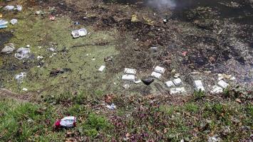 Environmental pollution found at a lake where people dumped their rubbish. photo