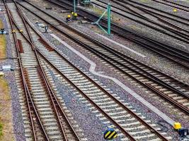 Multiple railroad tracks with junctions at a railway station in a perspective and birds view photo