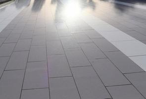 Diffuse reflections of pedestrians walking a marble sidewalk in dubai photo