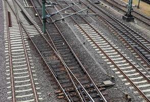 Multiple railroad tracks with junctions at a railway station in a perspective and birds view photo