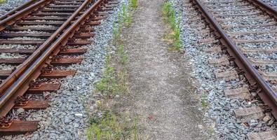 Multiple railroad tracks with junctions at a railway station in a perspective and birds view photo