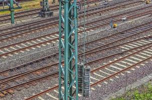 Multiple railroad tracks with junctions at a railway station in a perspective and birds view photo