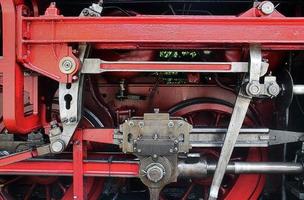 Old steam locomotive in black and red photo