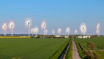 Panoramic view on alternative energy wind mills in a windpark with mulitple images blended photo