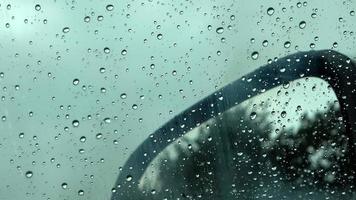 Rain drops running down a car window in a close up view. photo