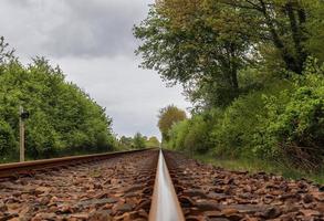 Multiple railroad tracks with junctions at a railway station in a perspective and birds view photo