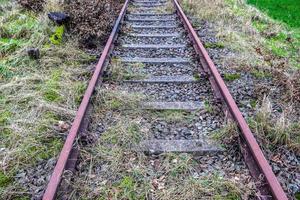 Multiple railroad tracks with junctions at a railway station in a perspective and birds view photo