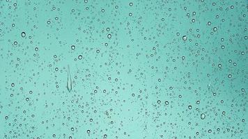 Rain drops running down a car window in a close up view. photo