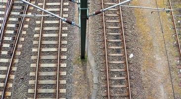 Multiple railroad tracks with junctions at a railway station in a perspective and birds view photo