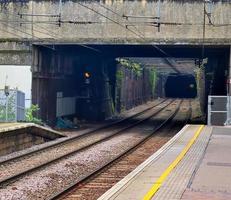 Multiple railroad tracks with junctions at a railway station in a perspective and birds view photo