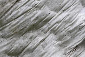 Close up view at the surface of a white marble stone. photo