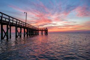 Pier on Mobile Bay at sunset photo