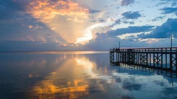 Pier on Mobile Bay at sunset photo