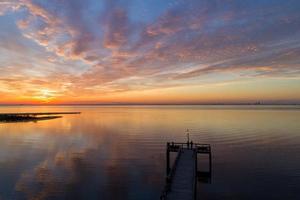 Pier on Mobile Bay at sunset photo