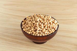 soybean in a bowl on wooden background, front view, selective focus. photo