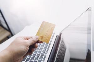 technology, people and online shopping concept - happy smiling man with tablet pc computer and credit card at home photo