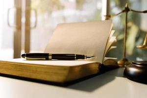 Business and lawyers discussing contract papers with brass scale on desk in office. Law, legal services, advice, justice and law concept picture with film grain effect photo