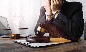 Business and lawyers discussing contract papers with brass scale on desk in office. Law, legal services, advice, justice and law concept picture with film grain effect photo