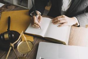 Business and lawyers discussing contract papers with brass scale on desk in office. Law, legal services, advice, justice and law concept picture with film grain effect photo