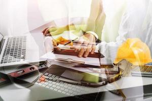 business hand working and laptop with on on architectural project at construction site at office desk in office photo