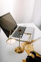 Business and lawyers discussing contract papers with brass scale on desk in office. Law, legal services, advice, justice and law concept picture with film grain effect photo