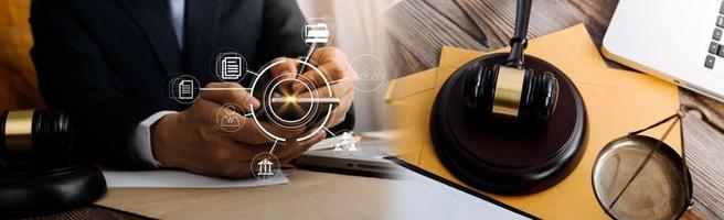 Justice and law concept.Male judge in a courtroom with the gavel, working with, computer and docking keyboard, eyeglasses, on table in morning light photo