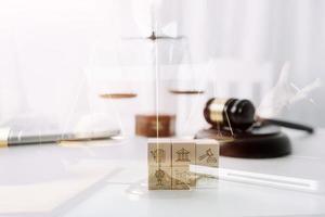 Justice and law concept.Male judge in a courtroom with the gavel, working with, computer and docking keyboard, eyeglasses, on table in morning light photo