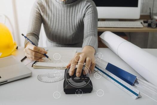 Two colleagues discussing data working and tablet, laptop with on on architectural project at construction site at desk in office photo