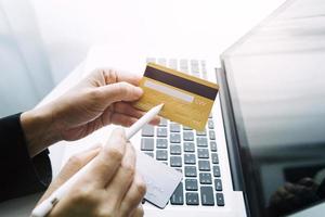 technology, people and online shopping concept - happy smiling man with tablet pc computer and credit card at home photo