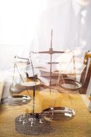 Justice and law concept.Male judge in a courtroom with the gavel, working with, computer and docking keyboard, eyeglasses, on table in morning light photo