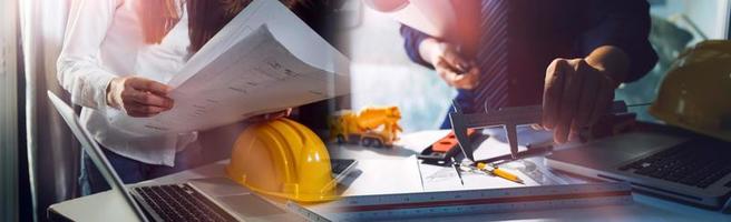 Two colleagues discussing data working and tablet, laptop with on on architectural project at construction site at desk in office photo