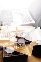 Justice and law concept.Male judge in a courtroom with the gavel, working with, computer and docking keyboard, eyeglasses, on table in morning light photo