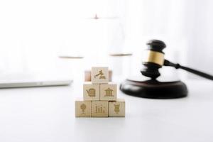 Business and lawyers discussing contract papers with brass scale on desk in office. Law, legal services, advice, justice and law concept picture with film grain effect photo